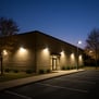 Commercial building at dusk with exterior lighting on