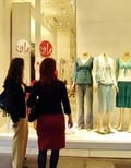 shoppers looking through window