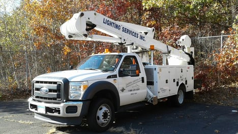 BUCKET TRUCK in Lighting Services parking lot