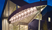 outside of building at night with lit canopy lights