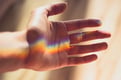 hand with colorful prism