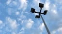 4-headed pole light against blue sky